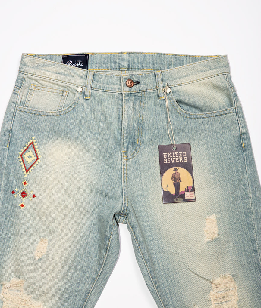 United Rivers Kansas River light denim jeans with five-pocket with zipper fly and signature snap rivets and “UR” label at the main button
