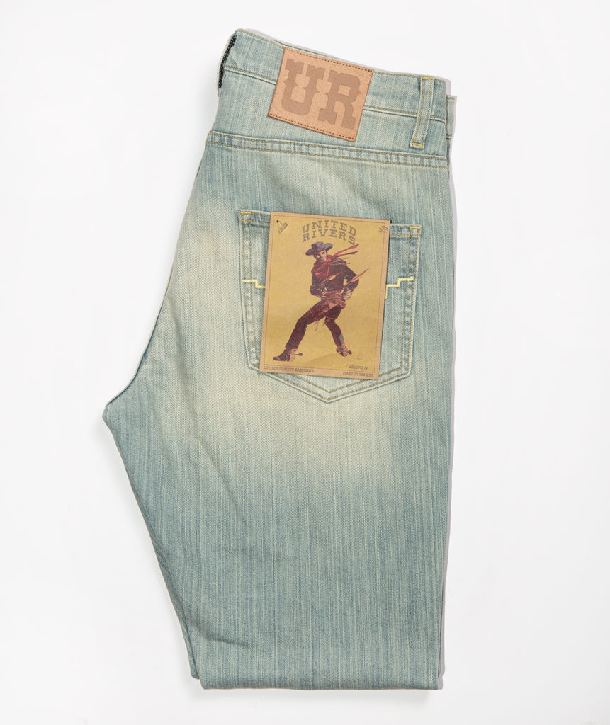 United Rivers Kansas River light denim jeans with leather “UR” signature patch at the back right waist